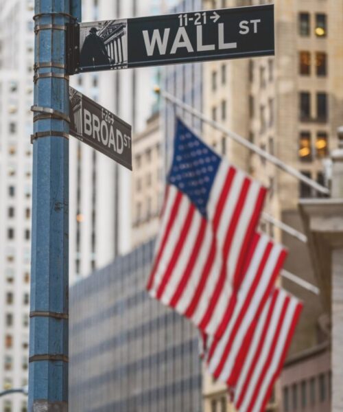 wall-street-wall-st-sign-and-broadway-street-over-american-national-flags